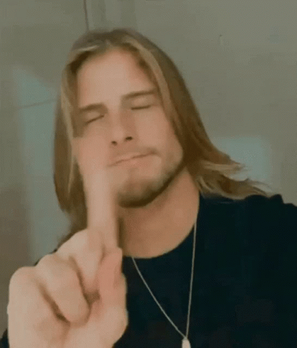Man With Long Hair and Beard Pointing Finger at Camera