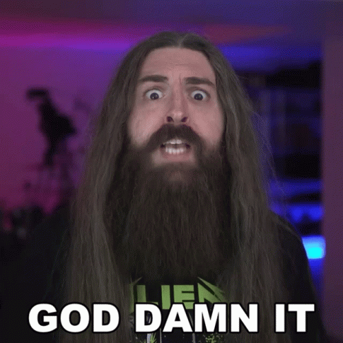 Man With Long Hair and Beard Saying God Damn It