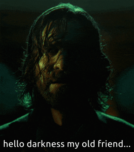 Man With Long Hair and Beard Says Hello Darkness My Old Friend