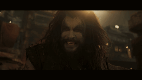 Man With Long Hair and Beard Screaming in the Dark