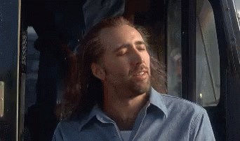 Man With Long Hair and Beard Sitting in Back Seat of Car
