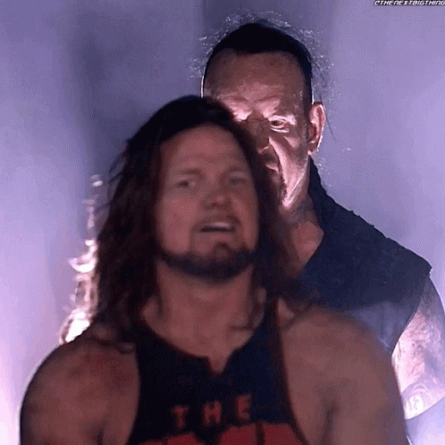 Man with Long Hair and Beard Wearing Undertaker Tank Top