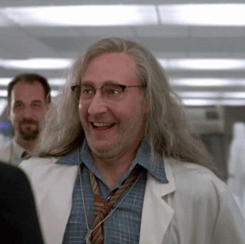 Man With Long Hair and Glasses in Lab Coat and Tie