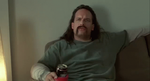 Man with Long Hair and Mustache Holding Beer