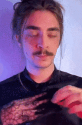 Man with Long Hair and Mustache in Black Lace Top