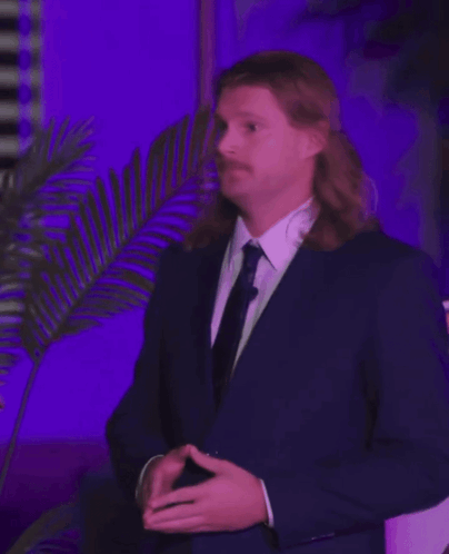 Man with Long Hair and Mustache in Suit