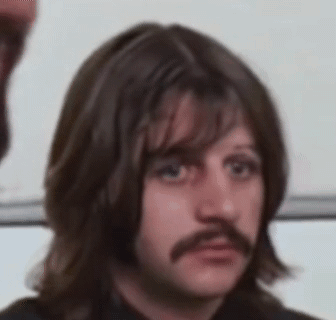 Man With Long Hair and Mustache Making Face