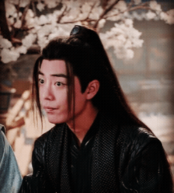Man With Long Hair and Ponytail in Black Jacket