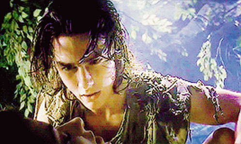 Man With Long Hair and Snake Around Neck Looking at Woman