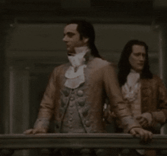 Man With Long Hair and White Tie Standing