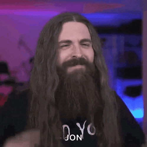 Man With Long Hair Beard and Shirt Saying Jon