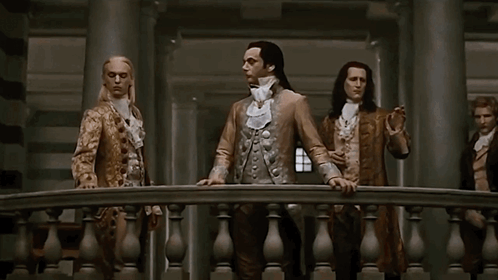 Man With Long Hair Between Two Men