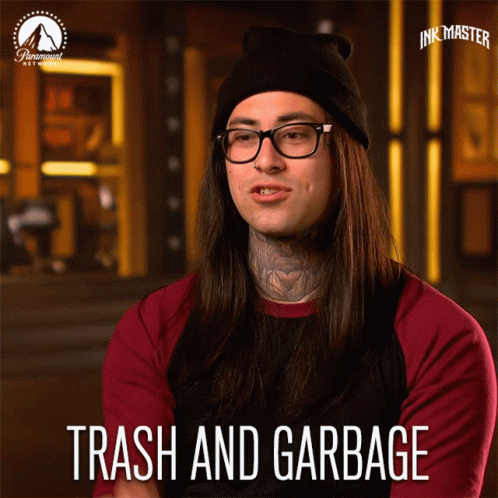 Man with Long Hair Glasses and Hat Saying Trash