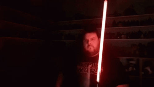 Man with Long Hair Holding Red Lightsaber