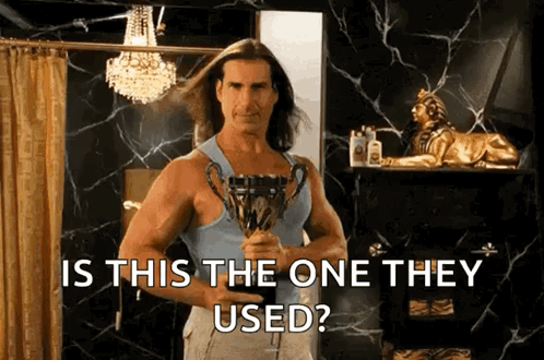 Man With Long Hair Holding Trophy GIF