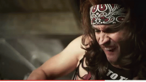Man With Long Hair in Bandana and Tot Shirt