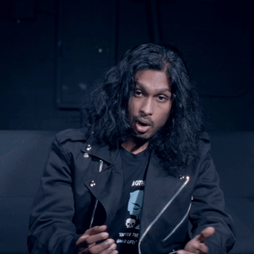 Man With Long Hair in Black Jacket Wearing Both T-Shirt