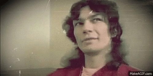 Man With Long Hair In Red Jacket GIF