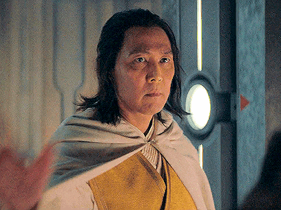 Man with Long Hair in White Cape