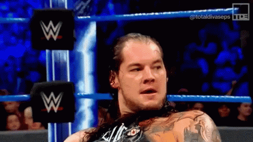Man With Long Hair In Wrestling Ring With W Logo GIF