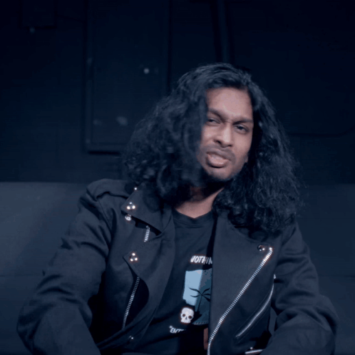Man With Long Hair Looking At Camera GIF