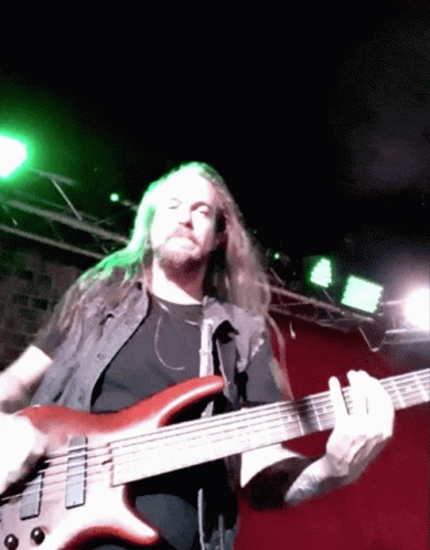 Man with Long Hair Playing Bass Guitar