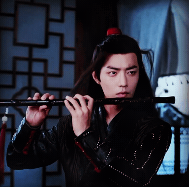 Man With Long Hair Playing Flute