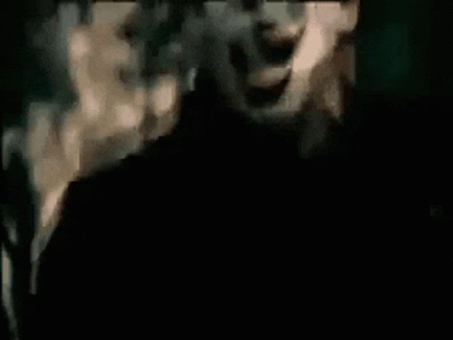 Man With Mask Screaming in Dark Room