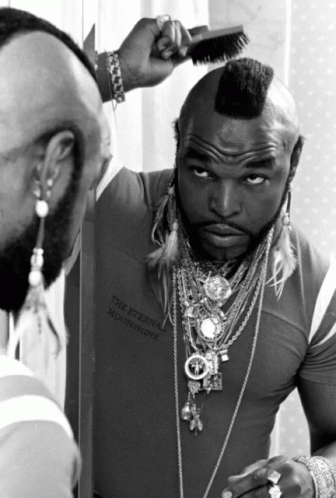 Man With Mohawk Looking In Mirror GIF