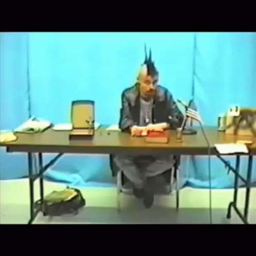 Man with Mohawk Sitting at Table