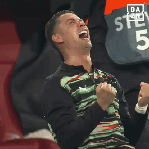 Man with Mouth Open and Fist in Air