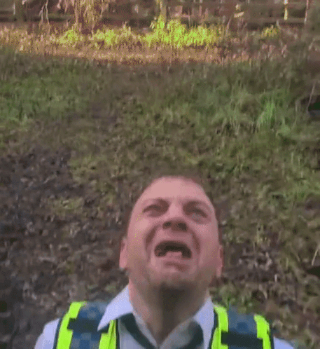 Man With Mouth Open in Yellow Vest