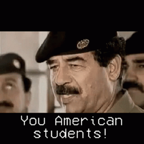 Man With Mustache And Beret Talking To Two Men GIF