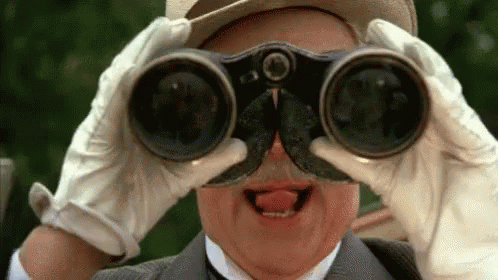 Man with Mustache and Gloves Looking Through Binoculars