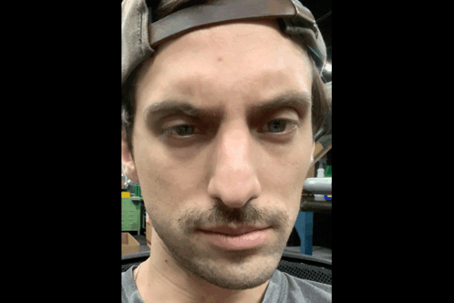 Man With Mustache and Hat Looking at Camera