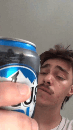 Man with Mustache Holding Blue J8 Beer