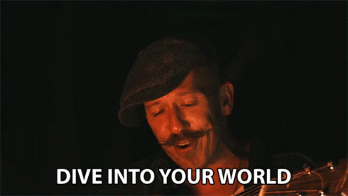 Man With Mustache Holding Guitar Says Dive Into Your World
