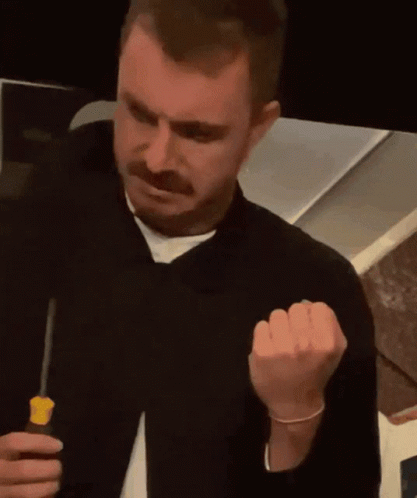 Man With Mustache Holding Screwdriver