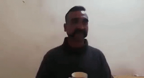 Man With Mustache Holding Tea Saying The Tea Is Fantastic GIF