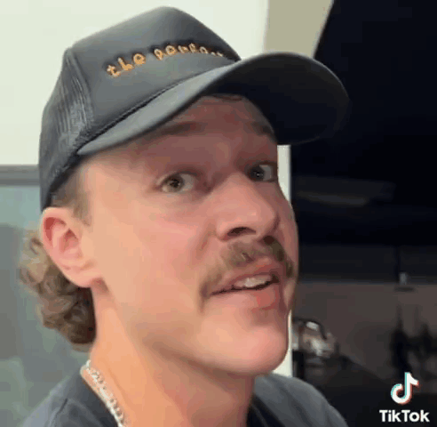 Man with Mustache in Black Hat