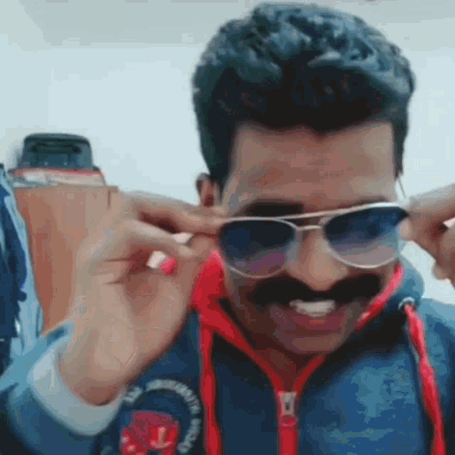 Man with Mustache in Blue Jacket and Sunglasses