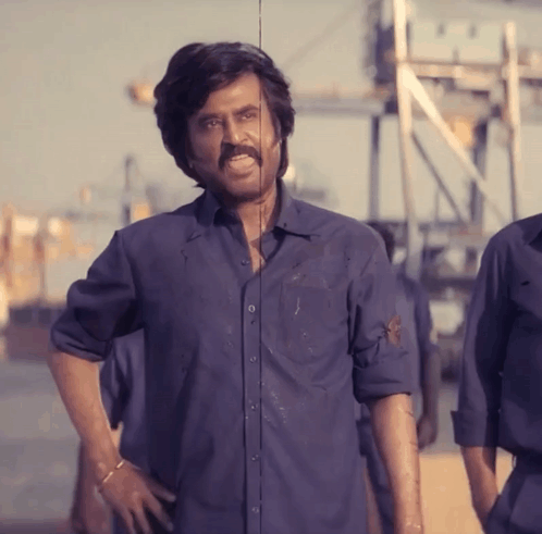 Man with Mustache in Blue Shirt Hands on Hips