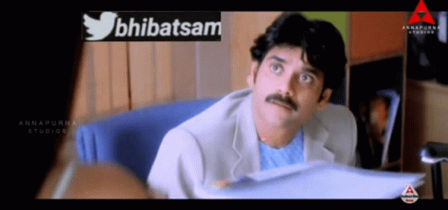 Man With Mustache In Front Of Abhatsam Sign GIF