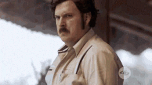 Man With Mustache In Front Of Building GIF