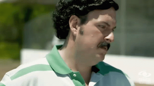 Man with Mustache in Green and White Shirt