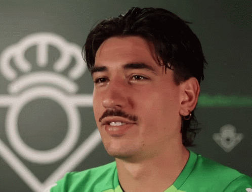 Man With Mustache in Green Shirt and White Crown