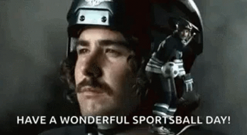 Man With Mustache in Helmet Holding Football and Soccer Ball