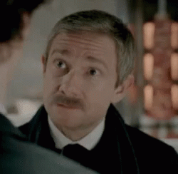 Man With Mustache In Tuxedo Looking At Another Man GIF