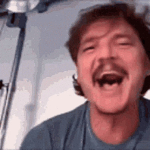 Man with Mustache Laughing in Blue Shirt