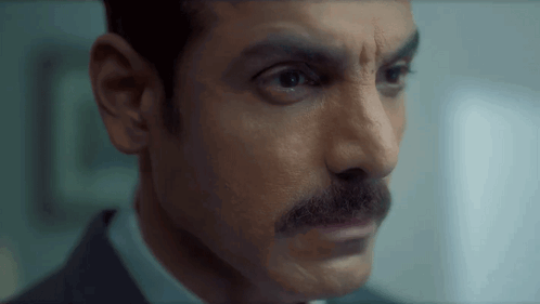 Man with Mustache Looking at Camera